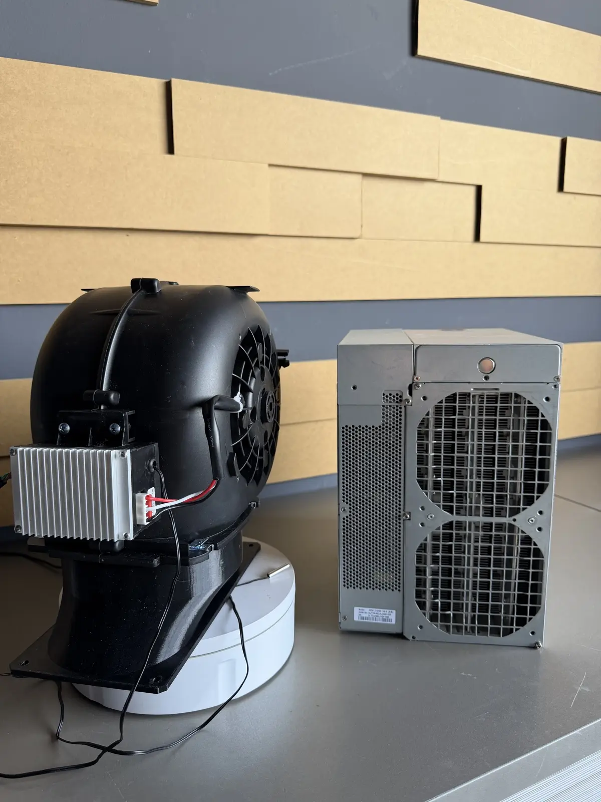 ASIC Miner Silencer Gen2 next to an Antminer for size comparison